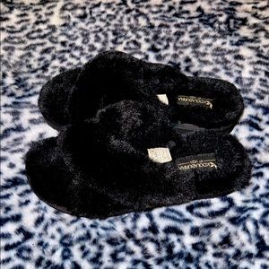 Black crossover slippers.